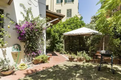 a courtyard with potted plants and a gazebo at Lemon Tree Apartment Sistine Chapel in Rome
