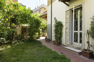 a garden outside a house with plants and a window at Lemon Tree Apartment Sistine Chapel in Rome