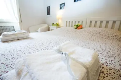 a bedroom with a white bed with a bow on it at I Prati Di Roma in Rome