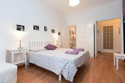 a bedroom with a bed with purple pillows on it at I Prati Di Roma in Rome