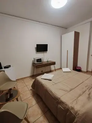 a bedroom with a large bed and a television at B&B Piazza Ragusa in Rome