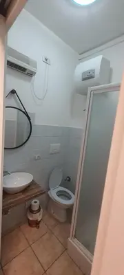 a bathroom with a toilet and a sink and a mirror at B&B Piazza Ragusa in Rome
