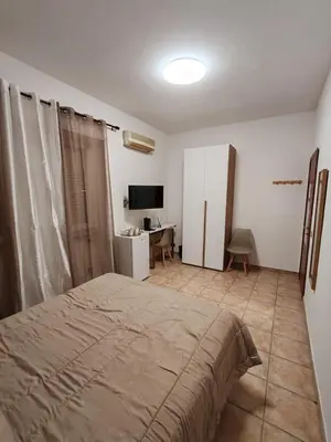 a bedroom with a bed and a desk and a television at B&B Piazza Ragusa in Rome