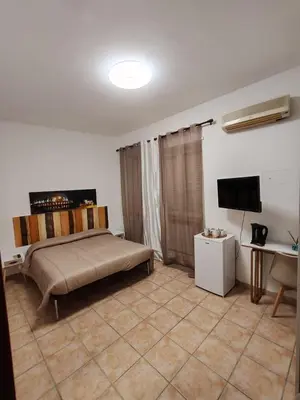 a bedroom with a bed and a flat screen tv at B&B Piazza Ragusa in Rome