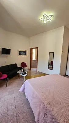 a bedroom with a bed with a red curtain at B&B Piazza Ragusa in Rome