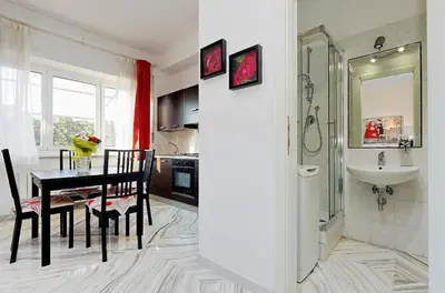a kitchen and dining room with a table and a sink at Holiday rental St Peter's area in Rome