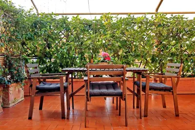 two chairs and a table in a garden at Holiday rental St Peter's area in Rome