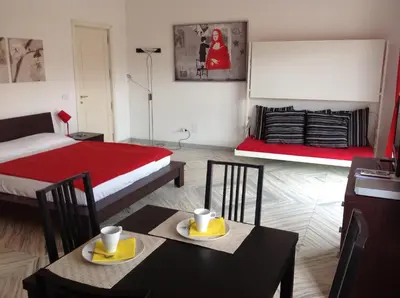 a room with a bed and two tables and chairs at Holiday rental St Peter's area in Rome