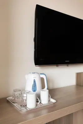 a tray with cups and a tv on a shelf at Fleming Suites by Hili in Rome