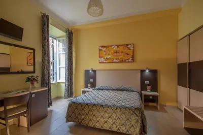 a bedroom with a bed and a table and a desk at Alex Place in Rome