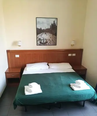a bedroom with a bed with two towels on it at Alex Place in Rome