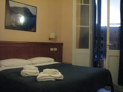 a bedroom with two towels sitting on a bed at Alex Place in Rome