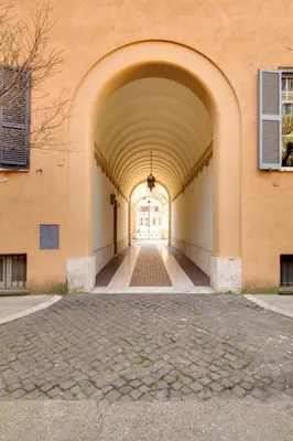an archway leading into a building with a window at Alex Place in Rome