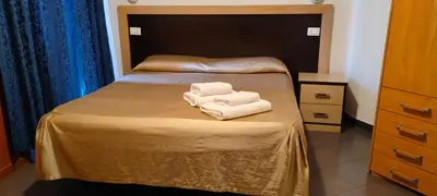 two towels sitting on a bed in a room at In Rome in Rome
