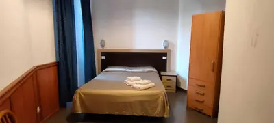 a small bedroom with a bed with two towels on it at In Rome in Rome