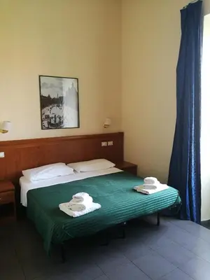 a hotel room with a bed with towels on it at In Rome in Rome