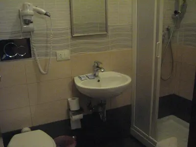 a bathroom with a sink and a toilet and a shower at In Rome in Rome