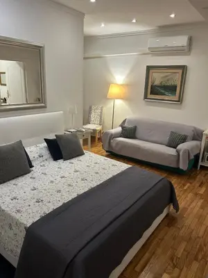 a bedroom with a large bed and a couch at Aurora 31 - Suite & Breakfast in Rome