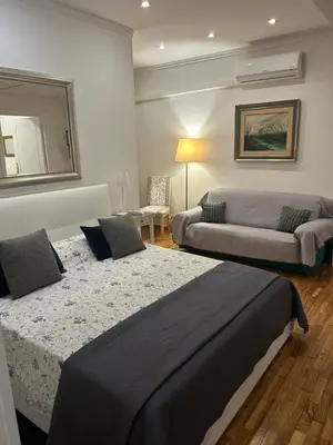 a bedroom with two beds and a couch at Aurora 31 - Suite & Breakfast in Rome