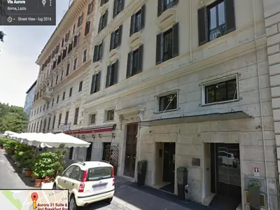 a white car parked in front of a building at Aurora 31 - Suite & Breakfast in Rome