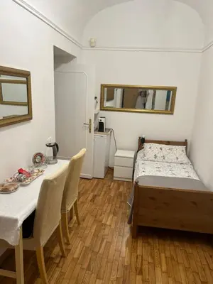 a bedroom with a bed and a table and chairs at Aurora 31 - Suite & Breakfast in Rome