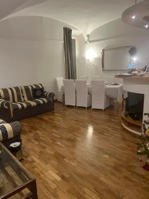 a living room with a couch and a table and chairs at Aurora 31 - Suite & Breakfast in Rome