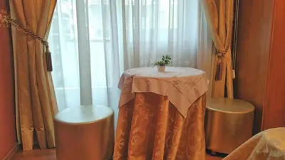 a table with a plant on it next to a window at Petite Maison in Rome
