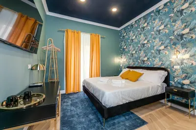 a bedroom with a bed and a sink in it at Suri Suites in Rome