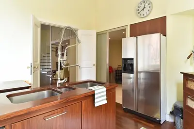 a kitchen with a sink and a refrigerator at Luxury House Belle Arti Rome City Center in Rome