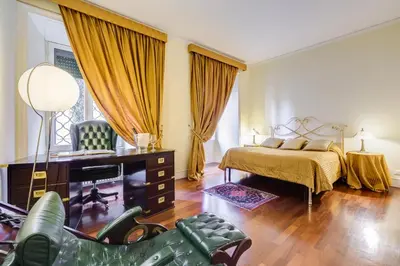 a bedroom with a bed and a tv in it at Luxury House Belle Arti Rome City Center in Rome