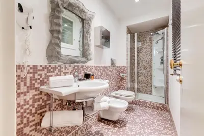 a bathroom with a sink and a toilet at Luxury House Belle Arti Rome City Center in Rome