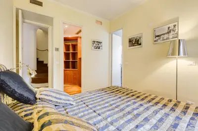 a bedroom with a bed and a lamp at Luxury House Belle Arti Rome City Center in Rome