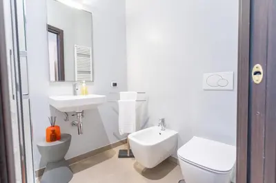 a white bathroom with a toilet and a sink at PgrHome Croce in Rome