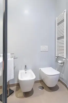 a white bathroom with a sink and a toilet at PgrHome Croce in Rome