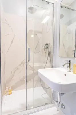 a white bathroom with a toilet and towels at PgrHome Croce in Rome