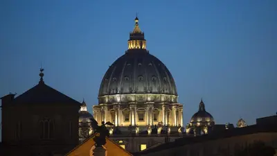 a view of the dome of a building at night at Beside the Vatican in Rome