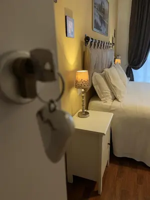 a room with a bed and a table with a lamp at Beside the Vatican in Rome