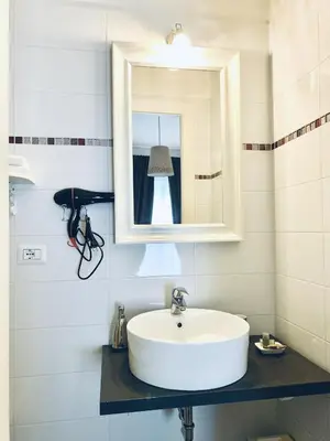 a bathroom with a white sink and a mirror at Beside the Vatican in Rome
