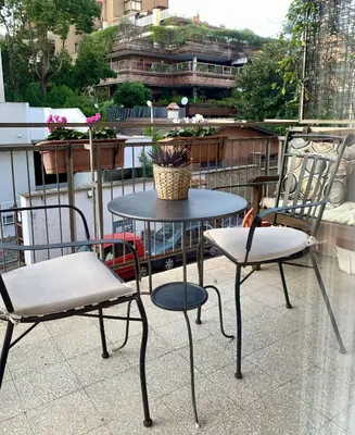 two chairs and a table on a balcony at Beside the Vatican in Rome