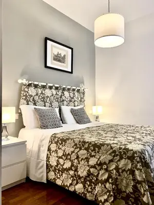 a bedroom with a bed with a black and white bedspread at Beside the Vatican in Rome