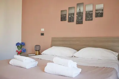 a bedroom with a bed with white pillows at Apartment in front of St Peter's Square and Vatican Museums - myPad in Rome in Rome