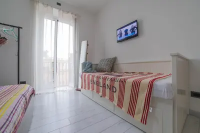 a bedroom with a bed with a striped blanket at Apartment in front of St Peter's Square and Vatican Museums - myPad in Rome in Rome