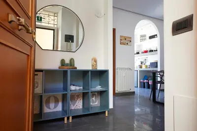 a hallway with a blue cabinet and a mirror at Apartment in front of St Peter's Square and Vatican Museums - myPad in Rome in Rome