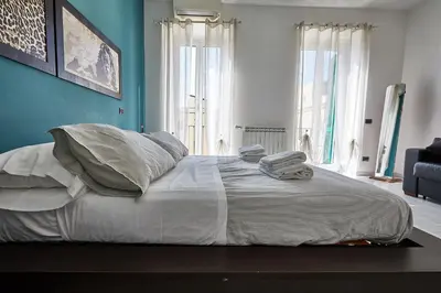 a bedroom with a large bed with towels on it at Apartment in front of St Peter's Square and Vatican Museums - myPad in Rome in Rome