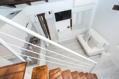 an overhead view of a living room with a staircase at Moro Magenta 1 Casa e Appartamento per Vacanze in Rome