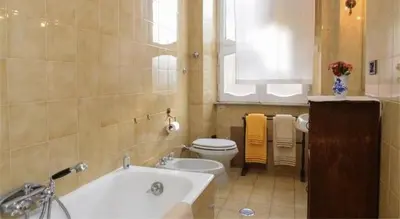 a bathroom with a tub and a toilet and a sink at B&B Villa Musa in Rome