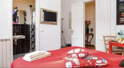 a bedroom with a red bed and a television on the wall at B&B Villa Musa in Rome