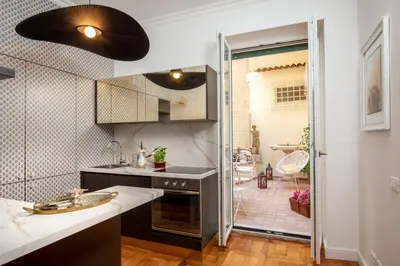 a kitchen with a sink and a shower backdoor at Casavignoni elegant 3BR home near to Spanish step in Rome
