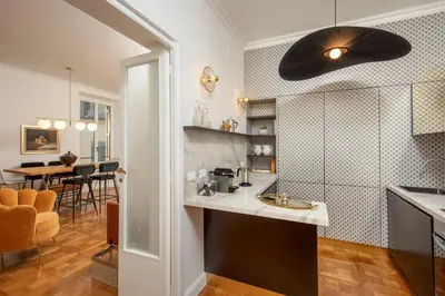a kitchen and living room with a ceiling fan at Casavignoni elegant 3BR home near to Spanish step in Rome