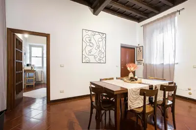 a dining room with a table and chairs at Trevi Fountain House Deluxe in Rome